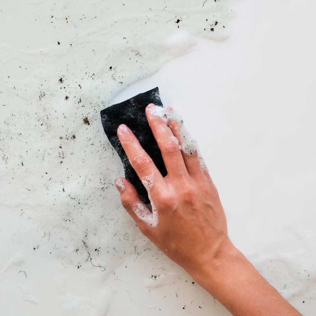 a hand with a sponge on a surface