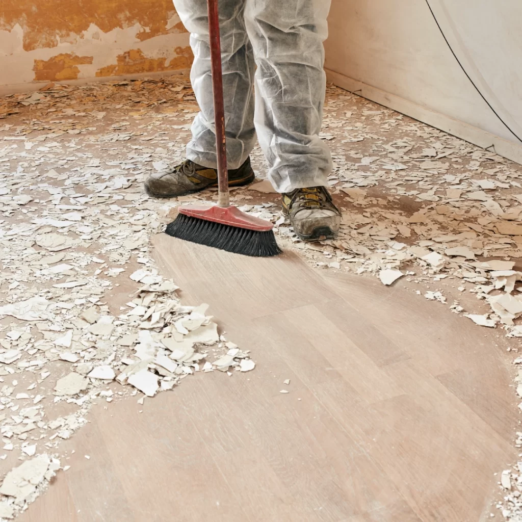 a person sweeping a floor with a broom