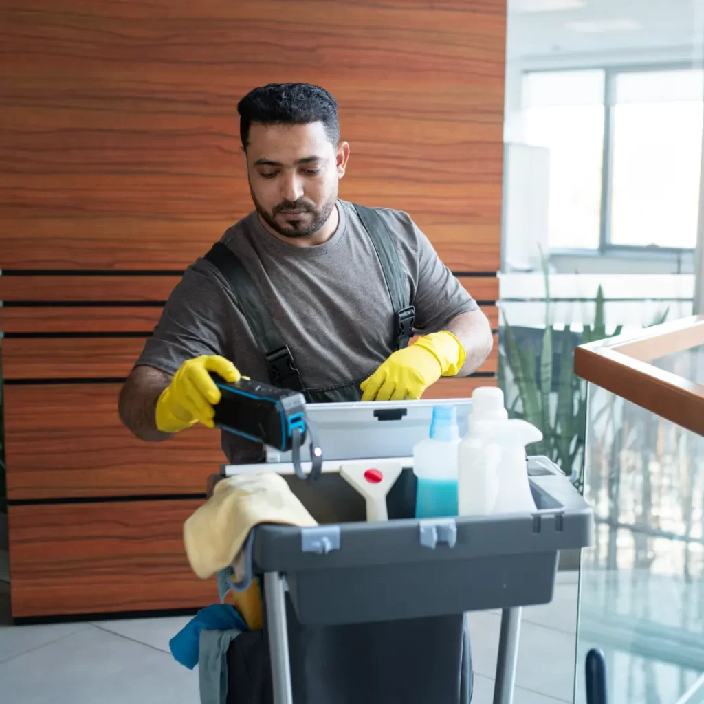 a person wearing gloves and holding a cleaning cart