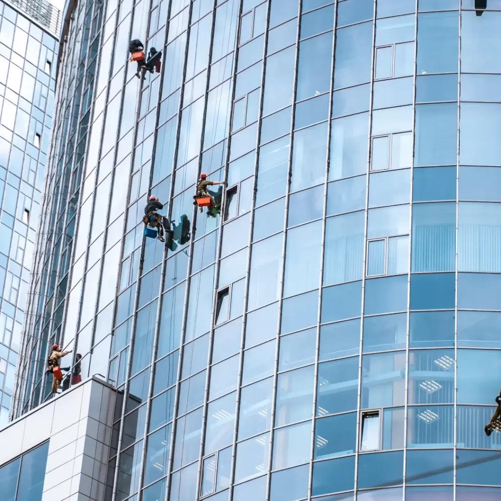 a group of people cleaning windows of a building