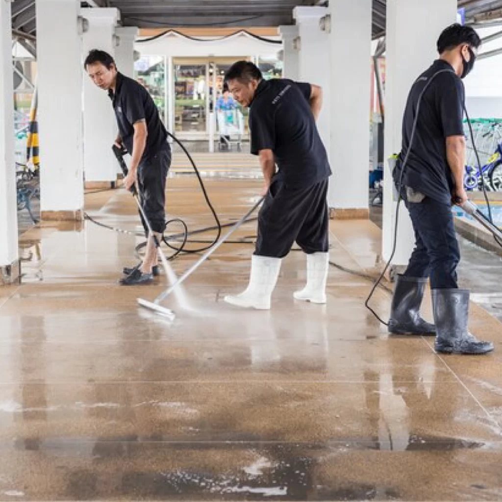 a group of men washing a floor