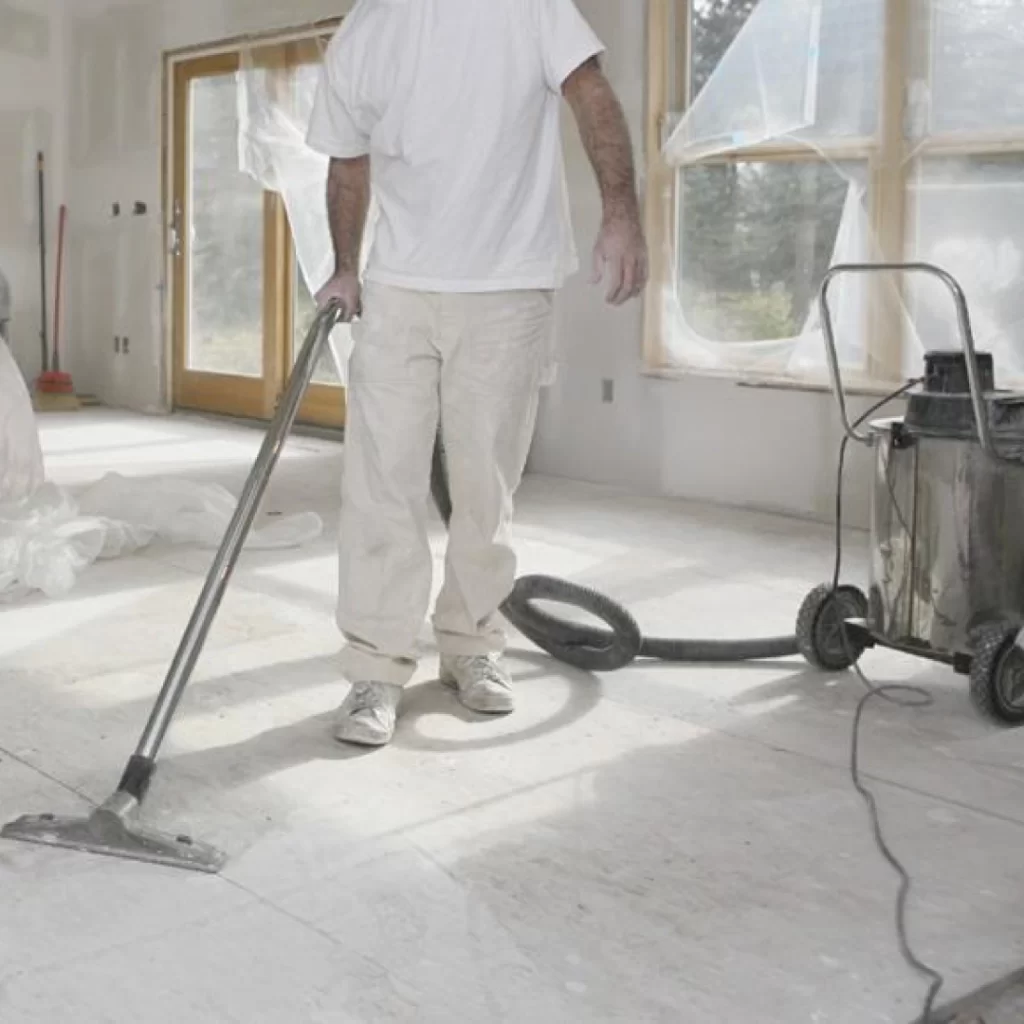 a person vacuuming a room