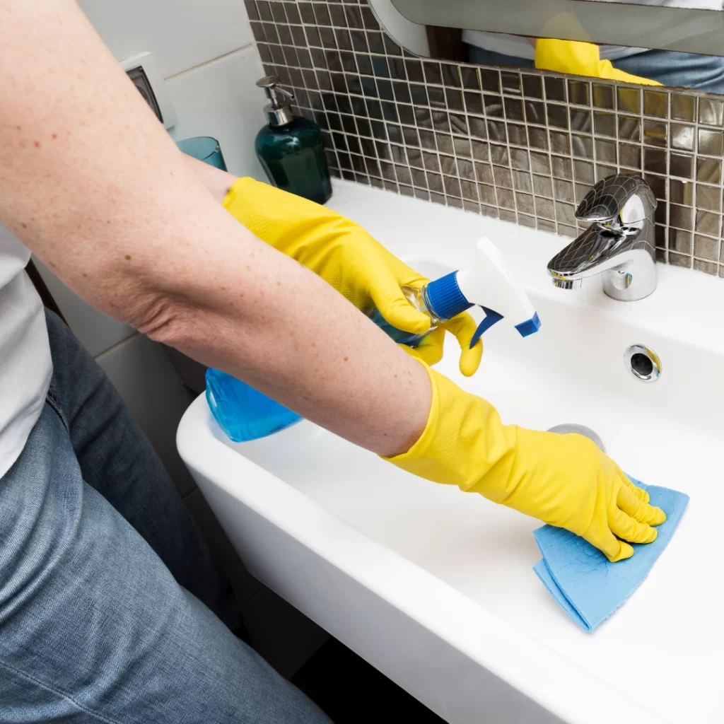 a person cleaning a sink