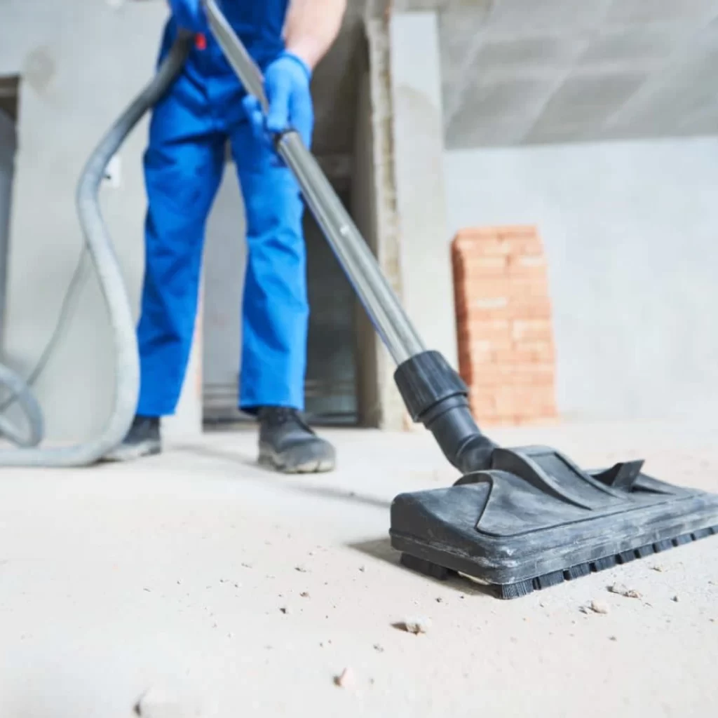 a person vacuuming the floor