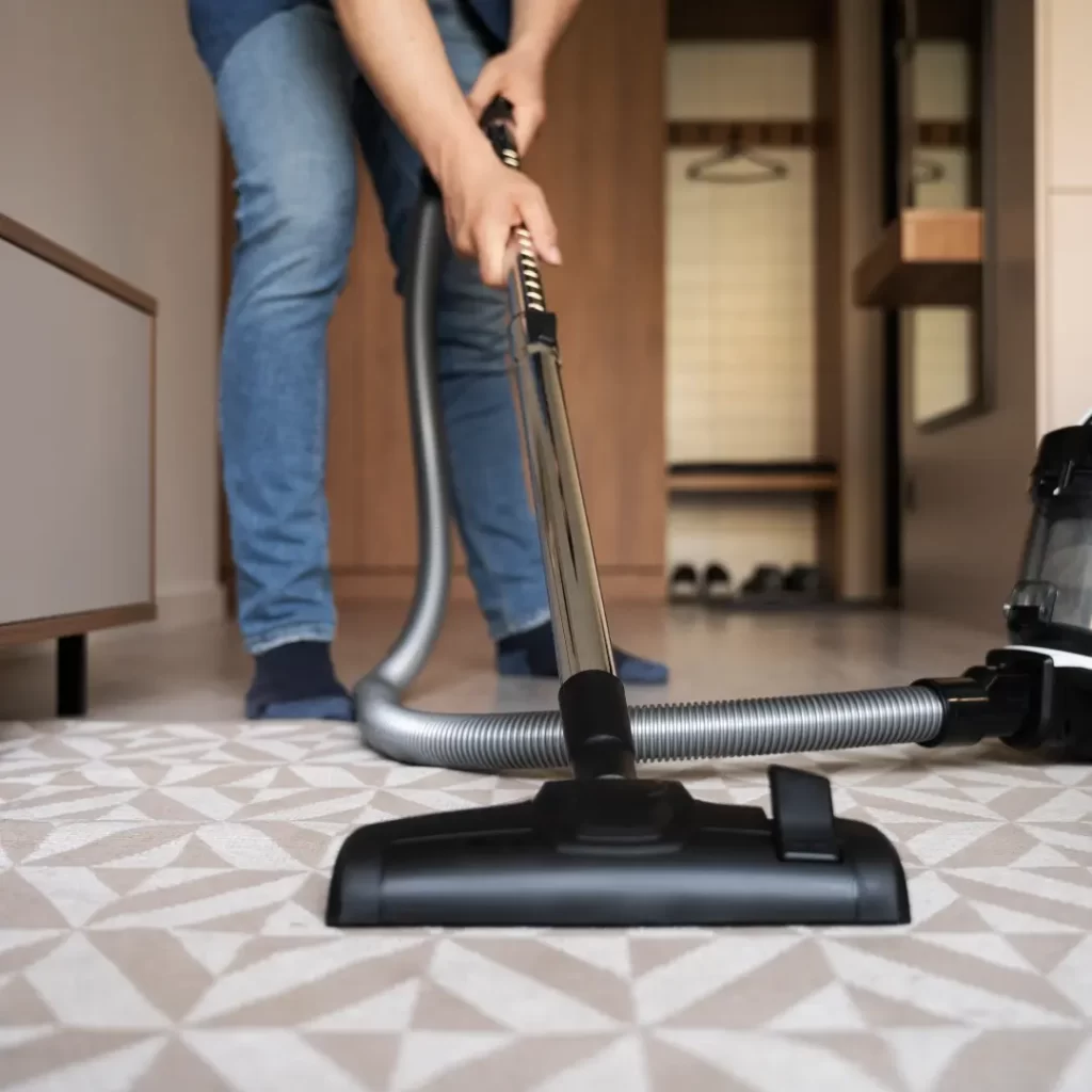 a person vacuuming the floor