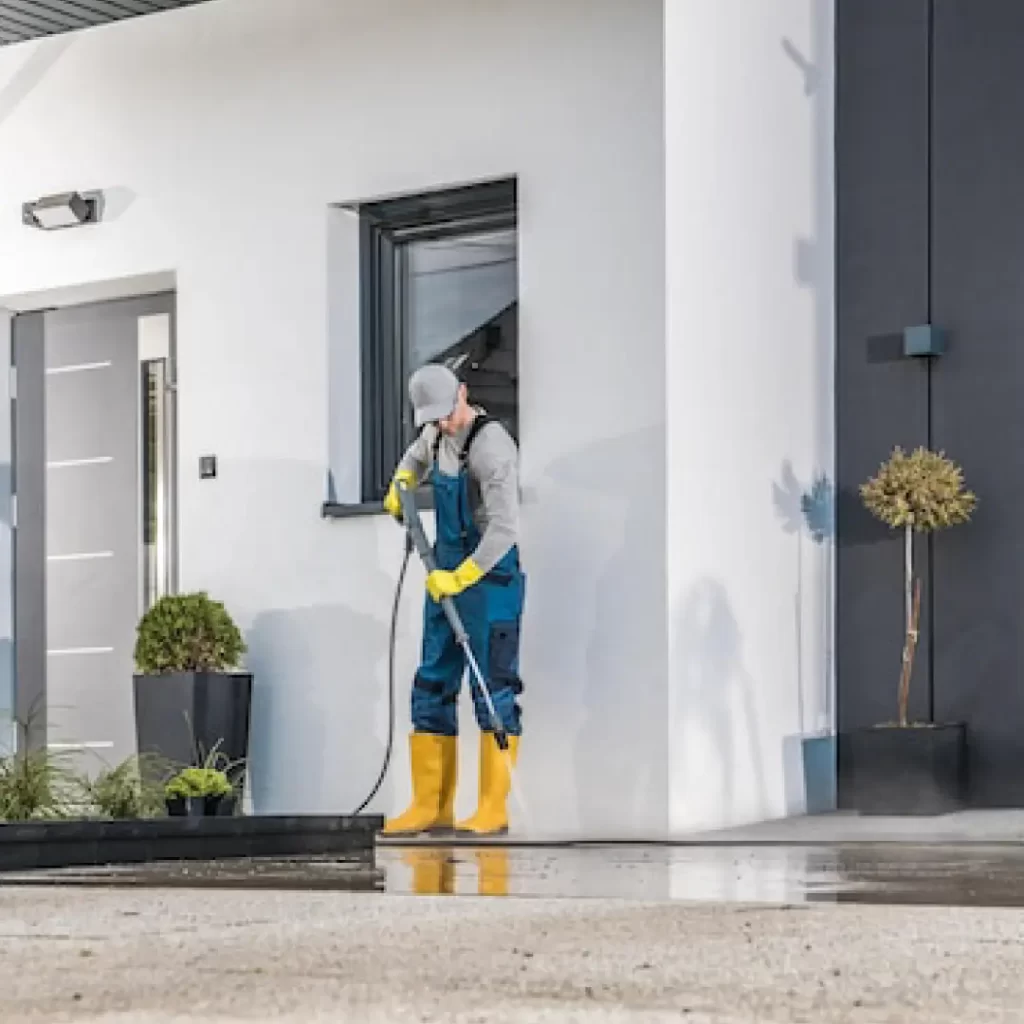 a person wearing yellow boots and standing outside a white building